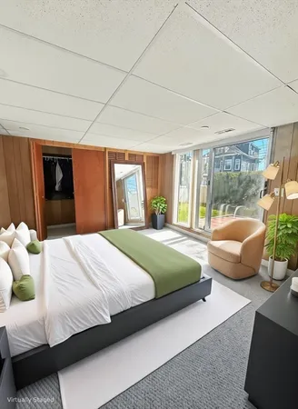 a bedroom with a bed and glass walk in closet