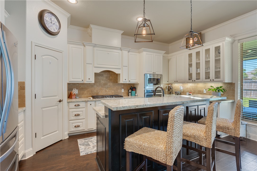 3301 Covington Court Bryan, TX 77808 - Photo 6 of 26 a kitchen with a table chairs stove and cabinets