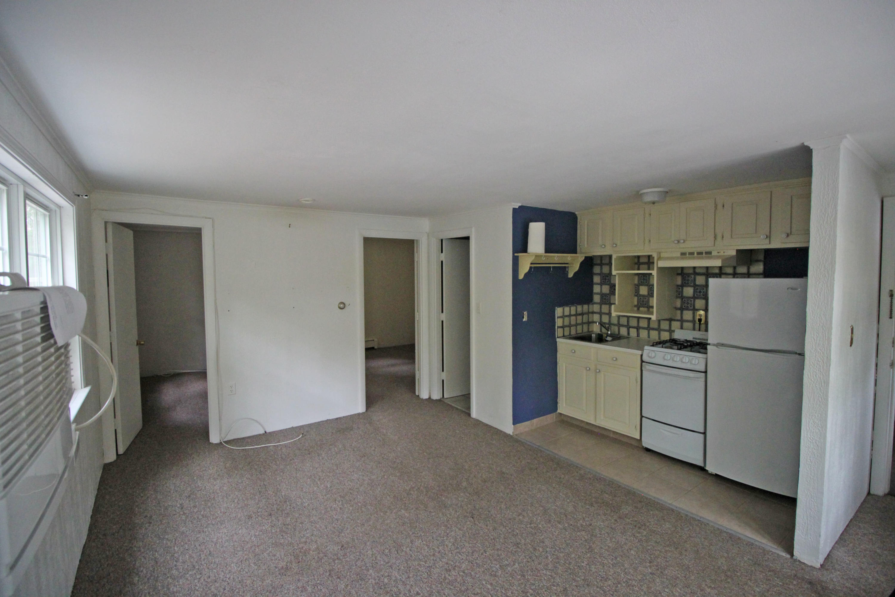 a kitchen with refrigerator and cabinets
