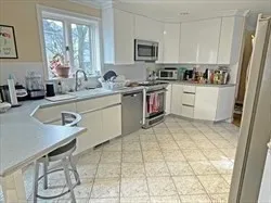 a kitchen with stainless steel appliances granite countertop a sink a stove and a refrigerator