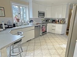 21 Hamlet Street, Unit 21 Newton, MA 02459 - Photo 11 of 15 a kitchen with stainless steel appliances granite countertop a sink a stove and a refrigerator