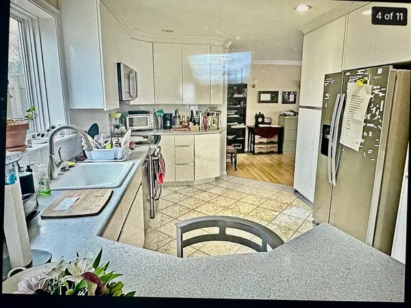 a kitchen with stainless steel appliances granite countertop a sink refrigerator and microwave