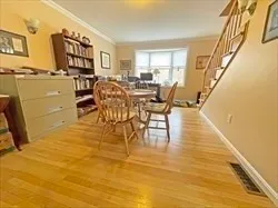 a dining room with furniture and wooden floor