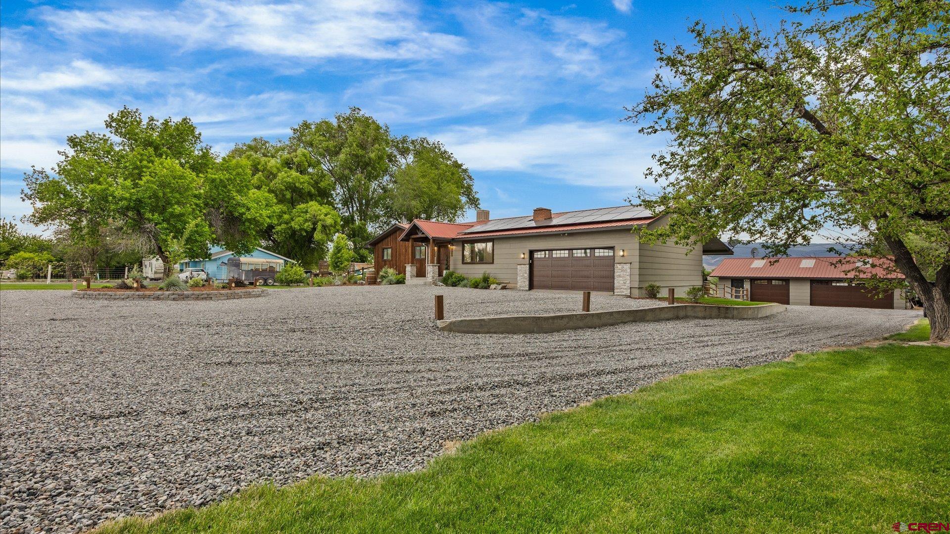 1761 G Road Delta, CO 81416 - Photo 33 of 43 a front view of a house with a yard and trees