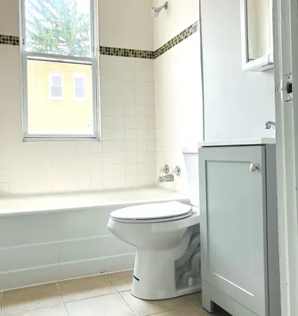 a bathroom with a toilet and a bathtub