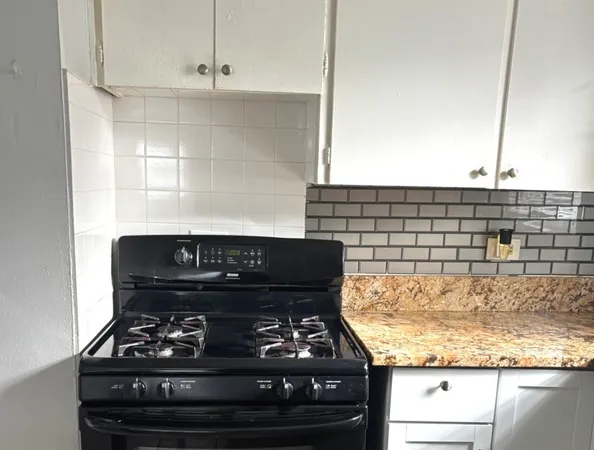 a stove top oven sitting inside of a kitchen