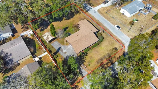 an aerial view of a house with a yard and swimming pool