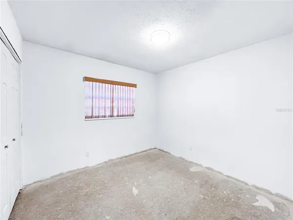 a view of a livingroom with a ceiling fan and window