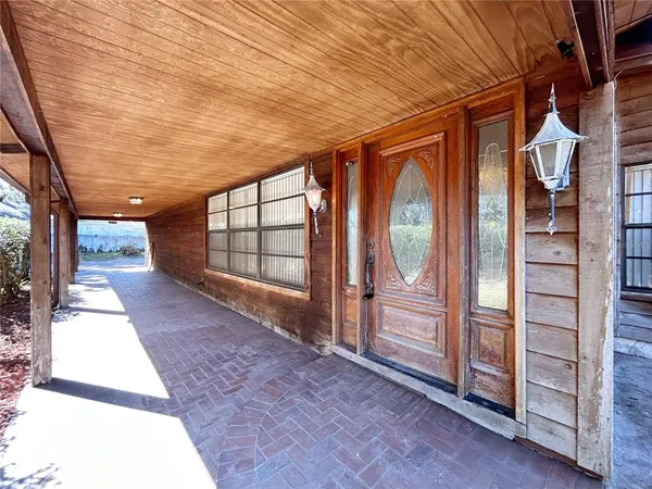 a view of a porch with wooden floor and iron stairs
