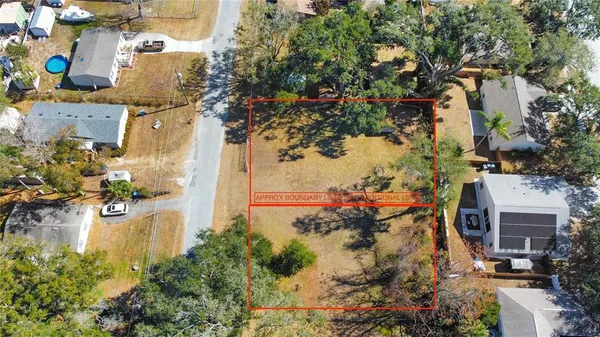 an aerial view of a houses with yard