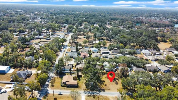 an aerial view of residential houses with city and ocean view