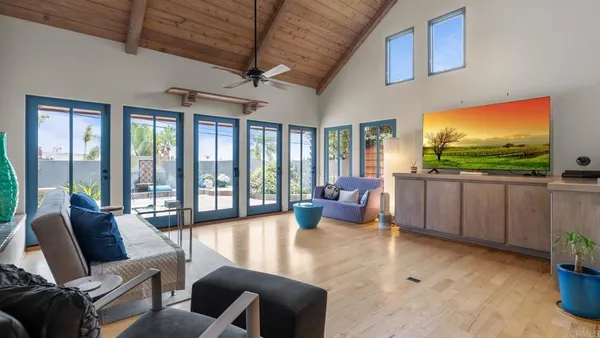 a spacious bedroom with a bed and a flat screen tv