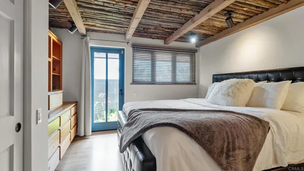 a large bed sitting in a bedroom next to a window