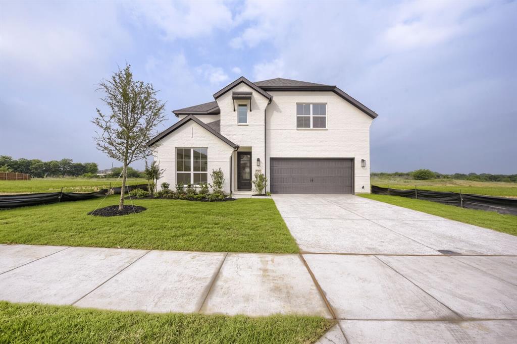 Contemporary two-story exterior featuring white brick and dark trim accents