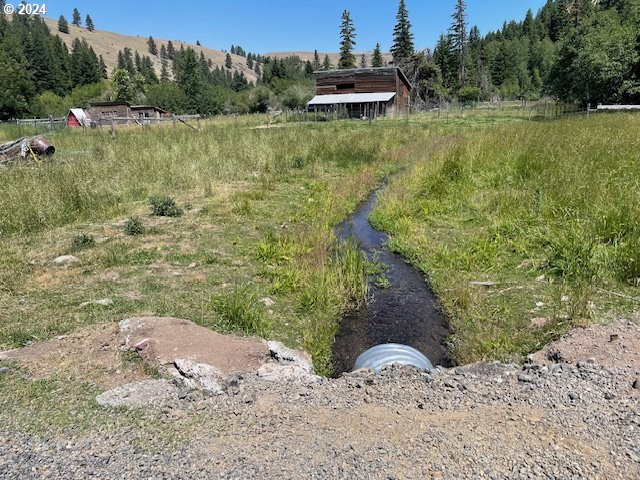62254 Wallowa Mtn Loop Road Joseph, OR 97846 - Photo 13 of 35 a view of a lake with a yard