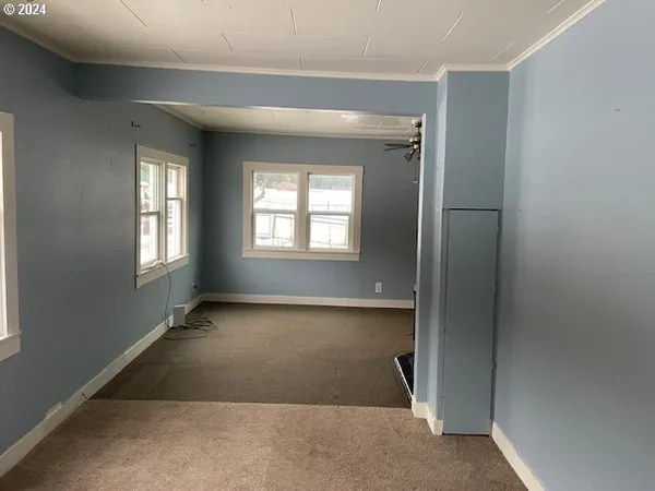 a view of a room with wooden floor