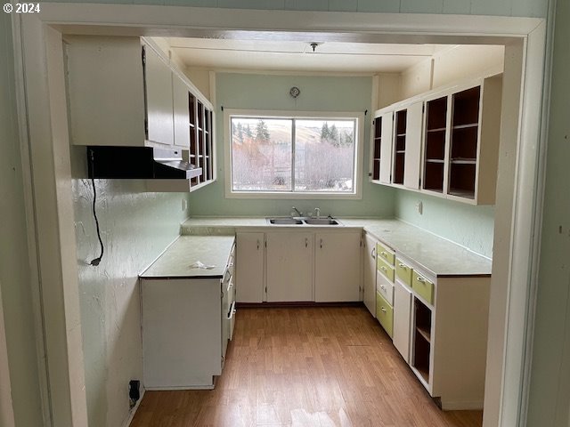 62254 Wallowa Mtn Loop Road Joseph, OR 97846 - Photo 34 of 35 a kitchen with a sink stove and cabinets