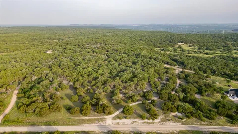 a view of a field with an ocean view