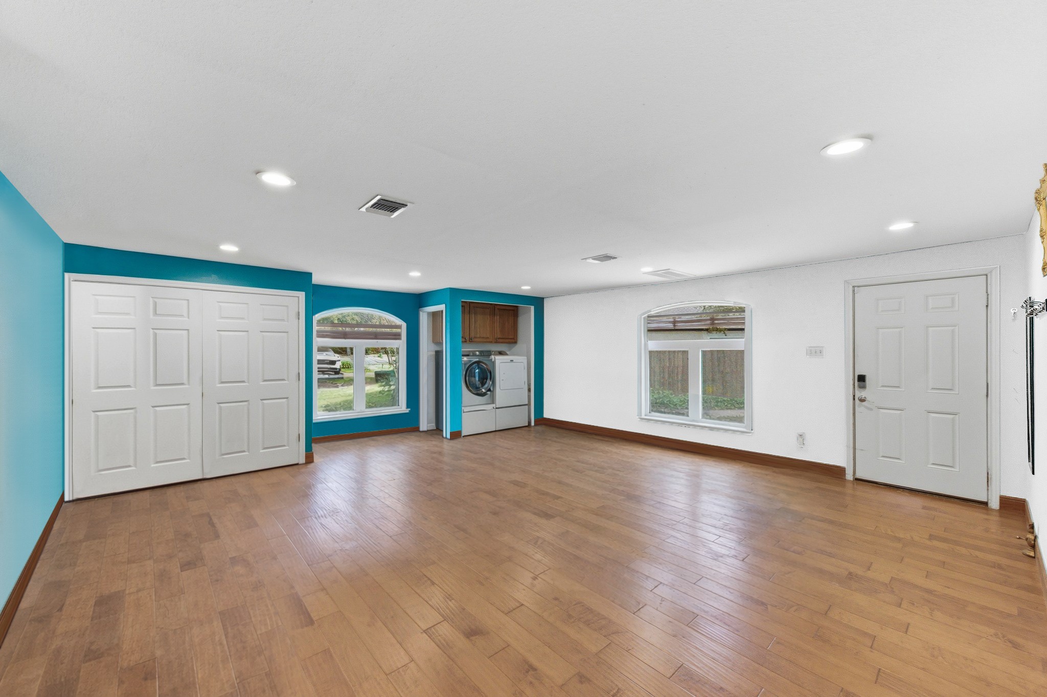 5705 Ballenton Court Austin, TX 78739 - Photo 15 of 30 a view of an empty room with a window and wooden floor