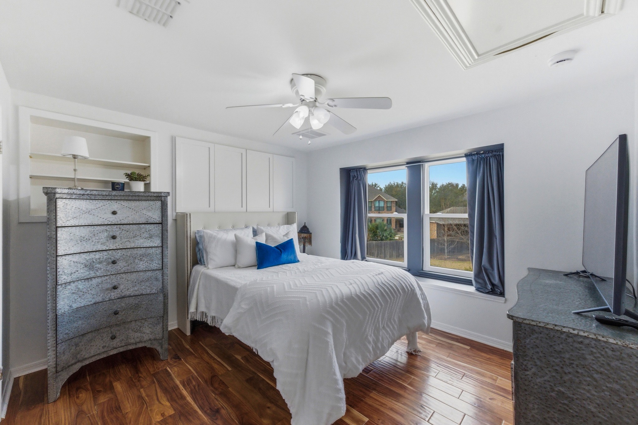 5705 Ballenton Court Austin, TX 78739 - Photo 21 of 30 a bedroom with a bed and a flat screen tv