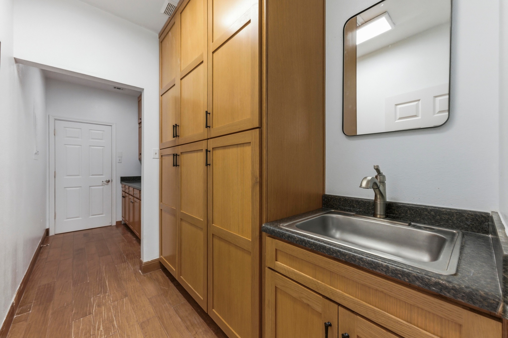 5705 Ballenton Court Austin, TX 78739 - Photo 25 of 30 a kitchen with a sink and refrigerator