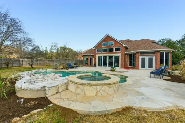 a swimming pool with outdoor seating and yard
