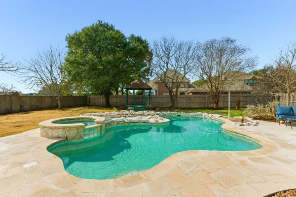 a view of a swimming pool with a yard