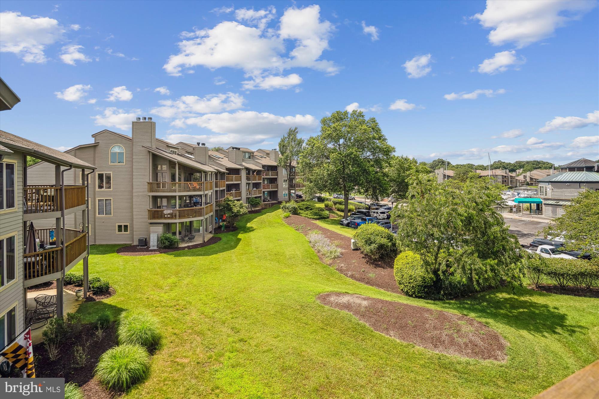 2108 Chesapeake Harbour Drive East, Unit 201 Annapolis, MD 21403 - Photo 13 of 82 a view of a swimming pool with an outdoor seating and a yard