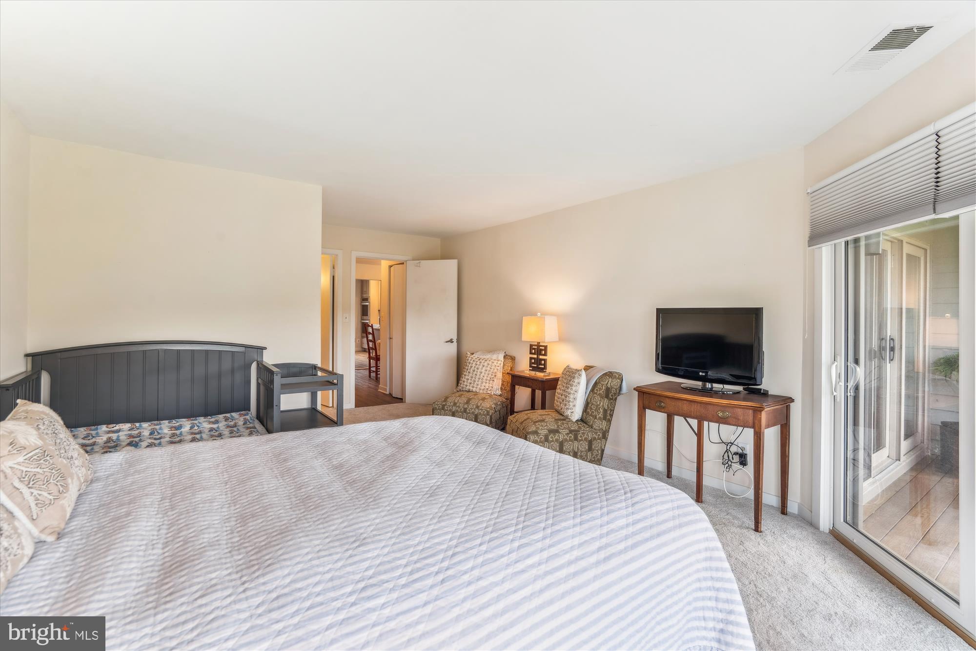 2108 Chesapeake Harbour Drive East, Unit 201 Annapolis, MD 21403 - Photo 24 of 82 a bedroom with a bed and a flat screen tv