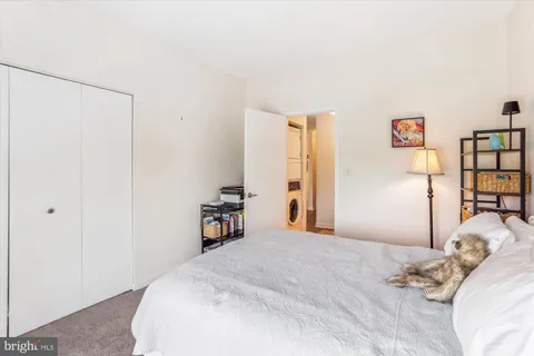 a bedroom with a bed and a large window