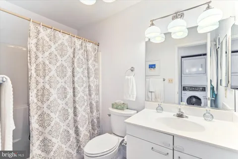 a bathroom with a sink toilet and shower curtain