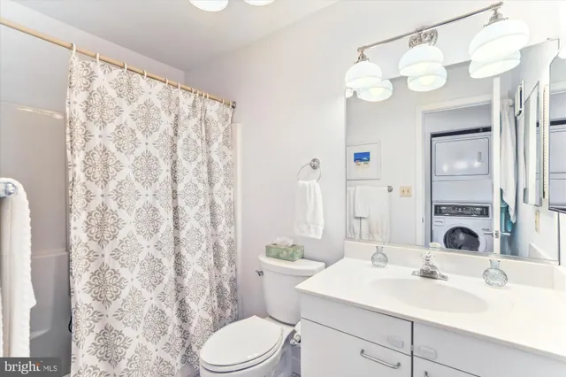 a bathroom with a sink toilet and shower curtain