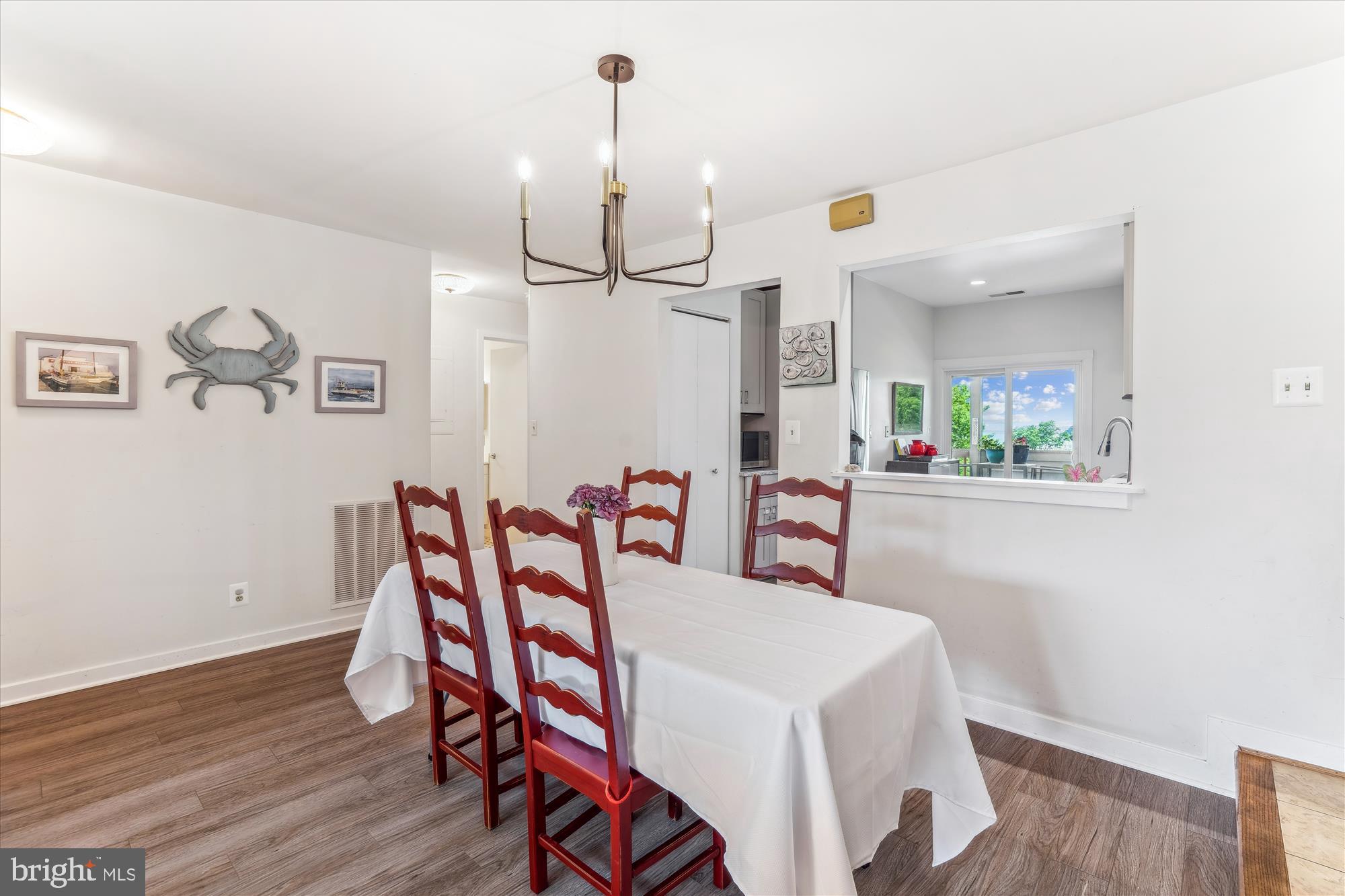 2108 Chesapeake Harbour Drive East, Unit 201 Annapolis, MD 21403 - Photo 4 of 82 a view of a dining room with furniture and wooden floor