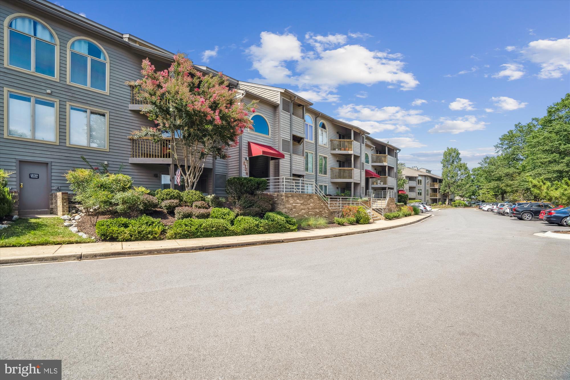 2108 Chesapeake Harbour Drive East, Unit 201 Annapolis, MD 21403 - Photo 49 of 82 a front view of a house with a garden and street view