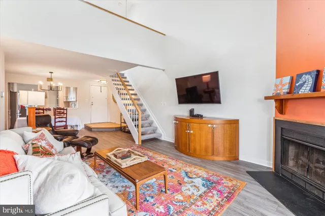 a living room with furniture a rug and a flat screen tv