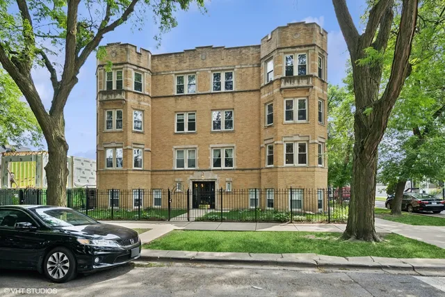 a car parked in front of a brick house next to a yard