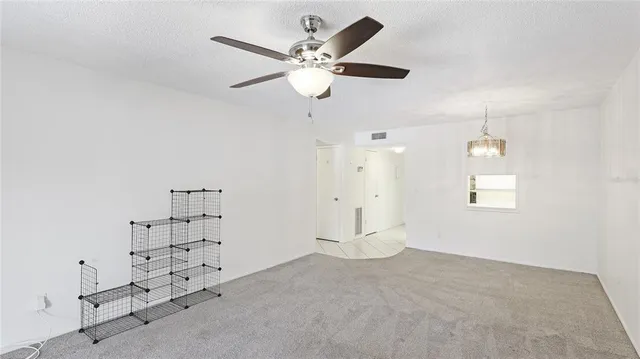 an empty room with closet and windows