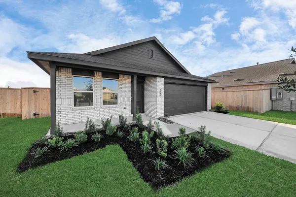 a front view of a house with a garden and plants