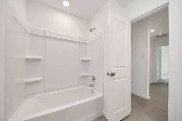 a bathroom with a bathtub and shower
