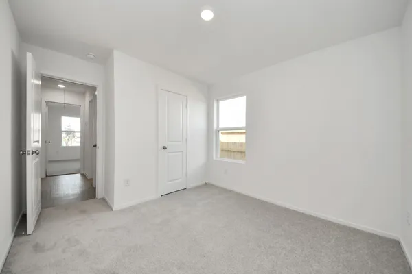 an empty room with a bathroom and a sink