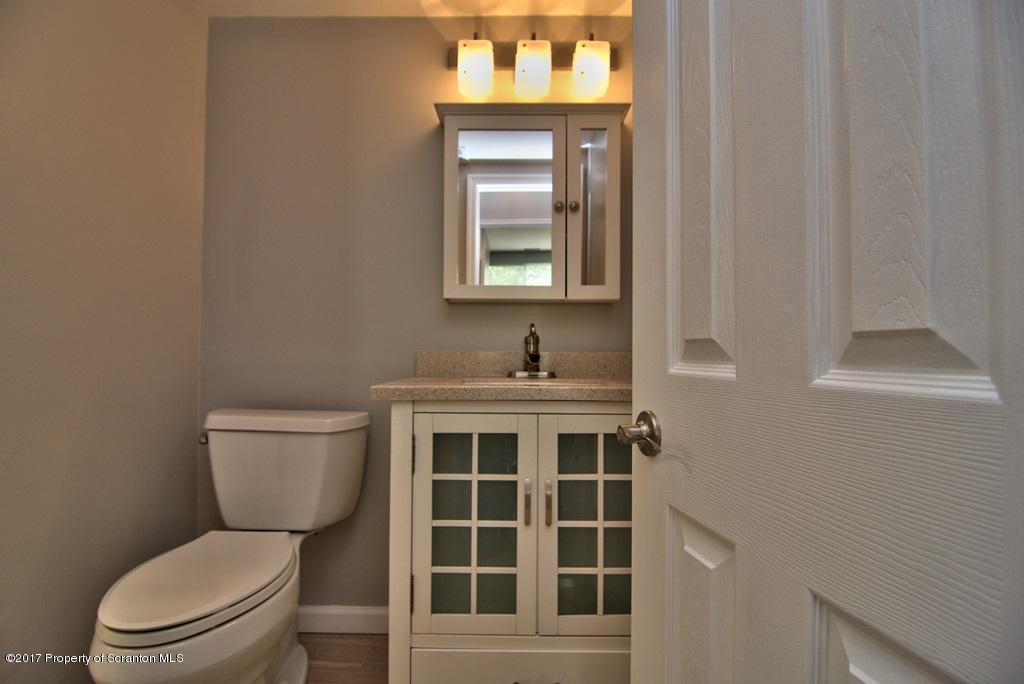 1211 Summit Pointe Scranton, PA 18508 - Photo 21 of 33 a bathroom with a toilet sink and mirror