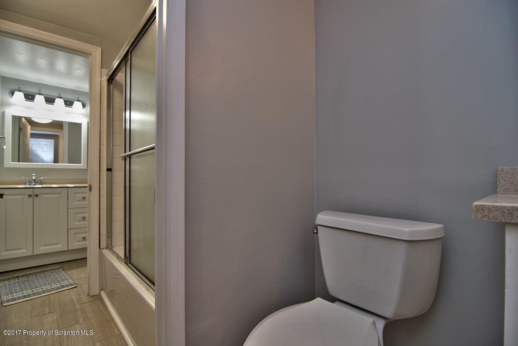 1211 Summit Pointe Scranton, PA 18508 - Photo 22 of 33 a white toilet sitting next to a bathroom sink