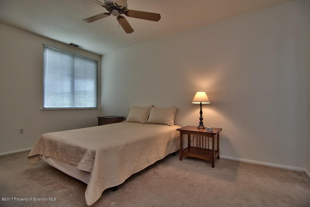 1211 Summit Pointe Scranton, PA 18508 - Photo 24 of 33 a bedroom with a bed and a lamp