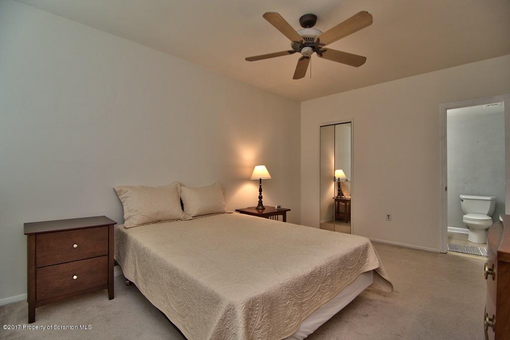 1211 Summit Pointe Scranton, PA 18508 - Photo 25 of 33 a bedroom with a bed and a chandelier