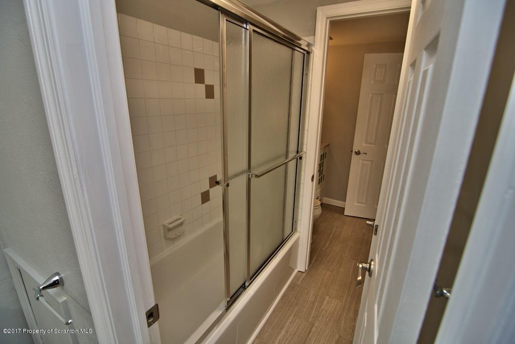 1211 Summit Pointe Scranton, PA 18508 - Photo 27 of 33 a bathroom with a glass door shower and a sink