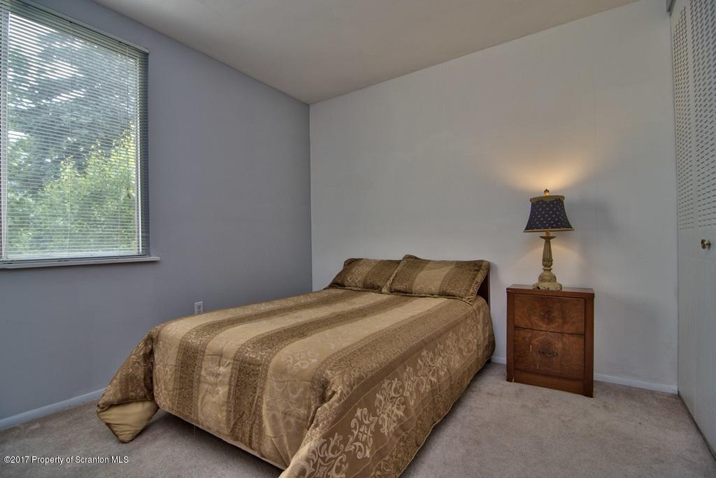 1211 Summit Pointe Scranton, PA 18508 - Photo 29 of 33 a bedroom with a bed lamp and window