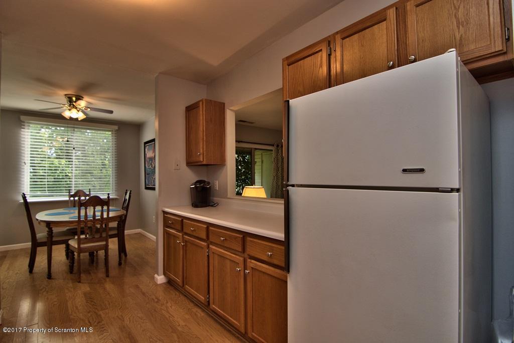 1211 Summit Pointe Scranton, PA 18508 - Photo 7 of 33 a kitchen with refrigerator a table and chairs