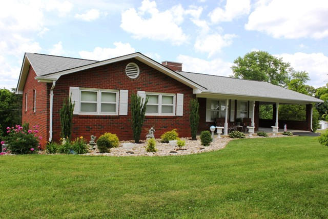 65 Iron Ridge Road Rocky Mount, VA 24151 - Photo 3 of 33 a front view of a house with garden