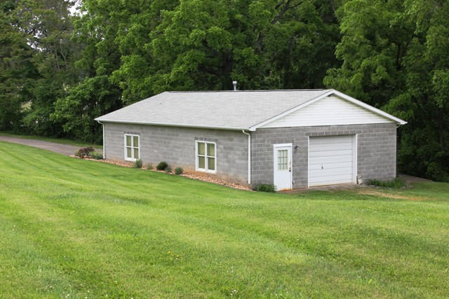 65 Iron Ridge Road Rocky Mount, VA 24151 - Photo 4 of 33 a front view of a house with a garden
