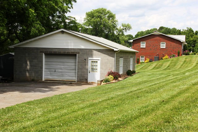 65 Iron Ridge Road Rocky Mount, VA 24151 - Photo 6 of 33 a front view of a house with a yard and garage